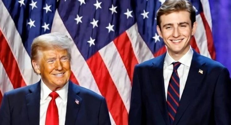 two men in suits stand smiling in front of American flags