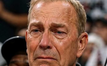 emotional man in crowd hearing sad news at event