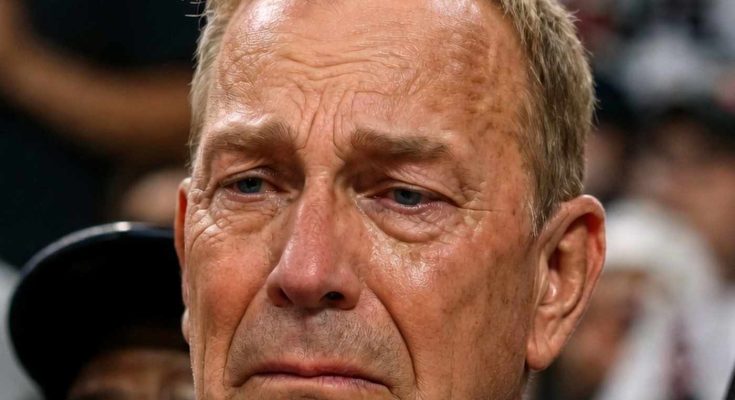 emotional man in crowd hearing sad news at event