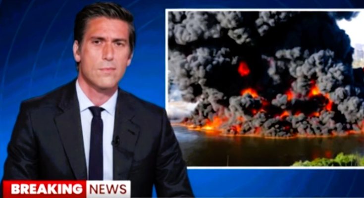 news anchor reports on massive fire with dark smoke