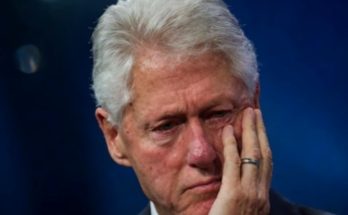 thoughtful man in suit with hand on face, deep in reflection