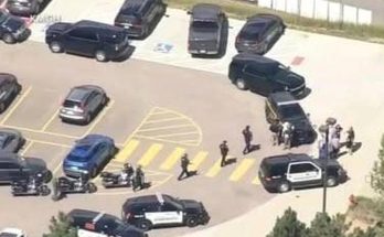 police vehicles and officers in parking lot during emergency response