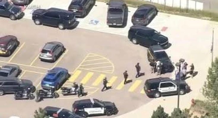 police vehicles and officers in parking lot during emergency response