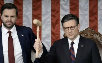two politicians in suits with a gavel, American flag backdrop