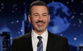 smiling man in suit with night sky backdrop