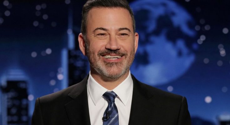 smiling man in suit with night sky backdrop