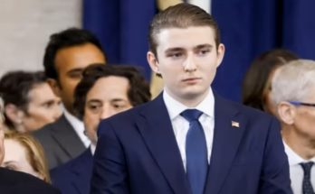 barron Trump in suit among officials, poised and composed