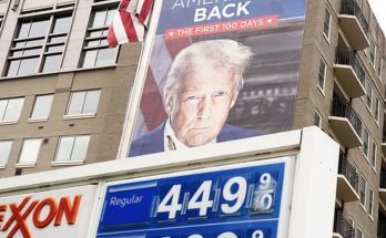 trump billboard above gas station with high prices displayed