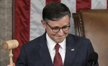 news figure speaking in a news photo