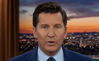 news anchor in blue suit delivering evening report
