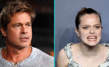 two celebrities in intense conversation at a public event