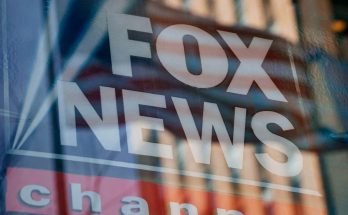 fox News logo reflection on city building window