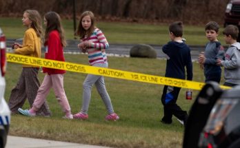 children walk past police tape in suburban neighborhood, focus on safety