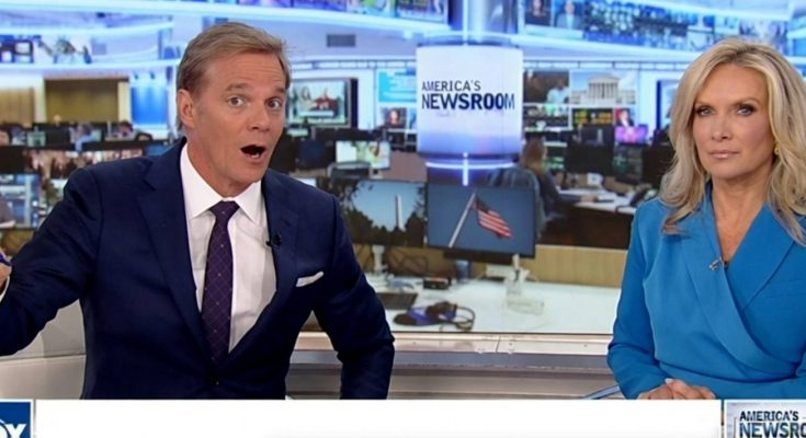 news anchors discussing current events in a busy newsroom